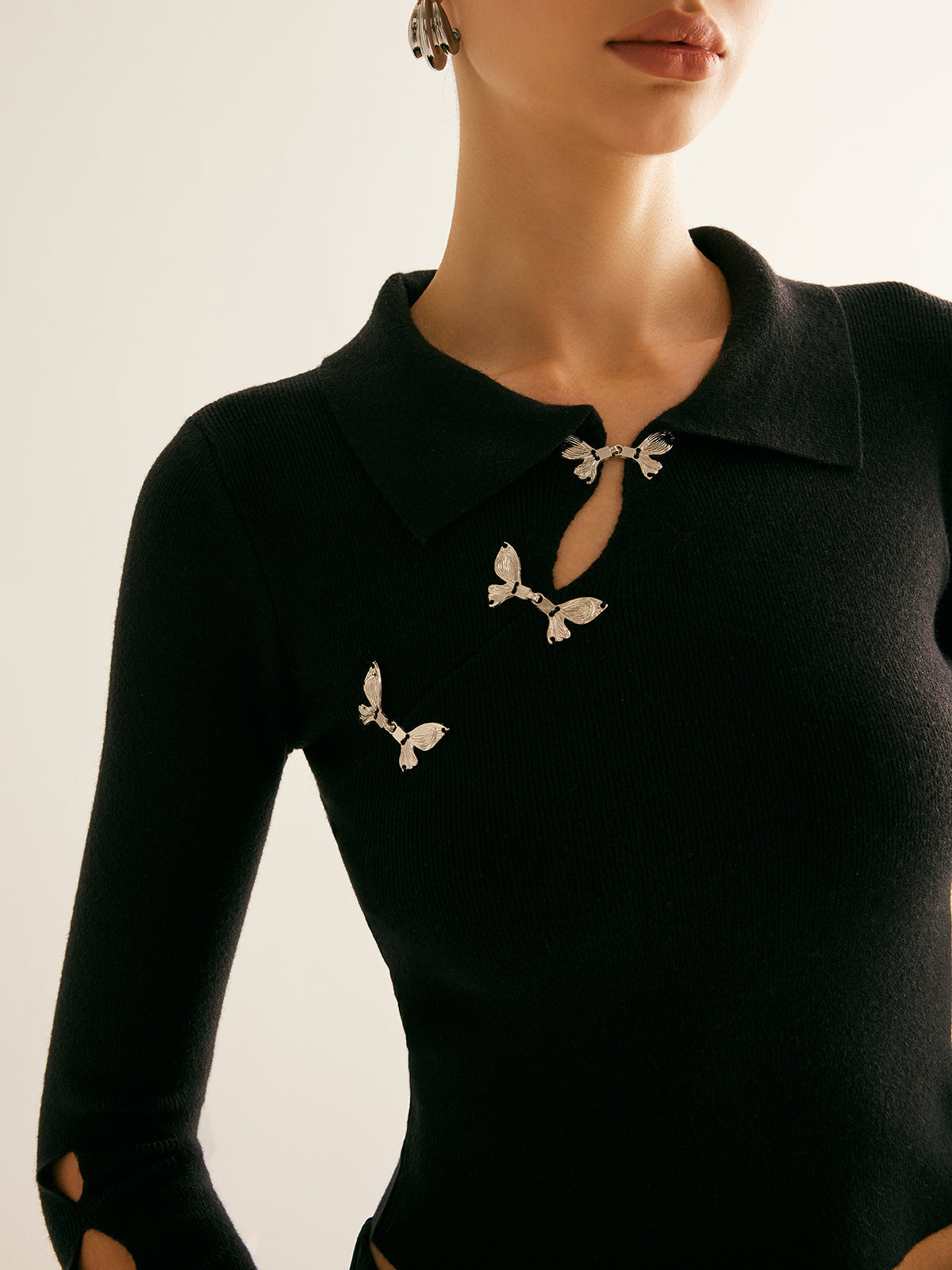 Krótki sweter z wycięciem pod szyją zdobiony metalem