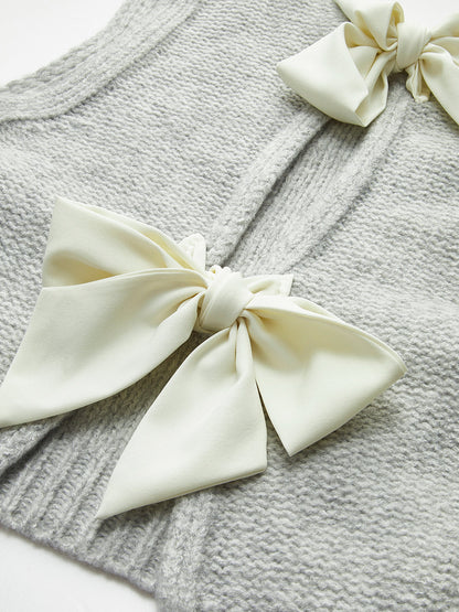 Dzianinowa bluzka z kokardą z przodu